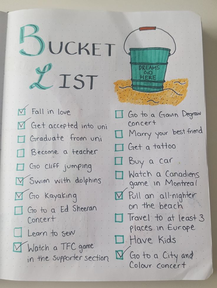 an open book with writing on it and a bucket list in the middle, sitting on top of a table