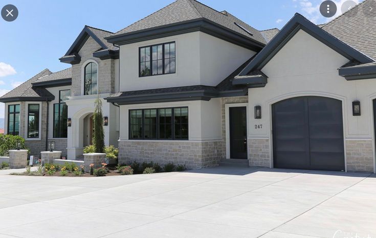 a large white house with two garage doors