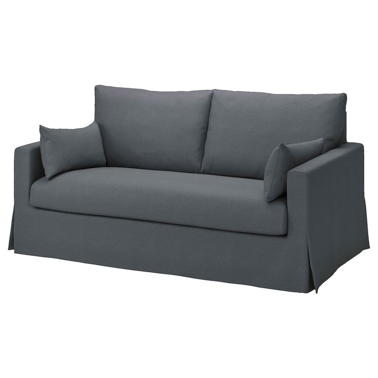 a gray couch with two pillows on it's back and one arm facing the camera