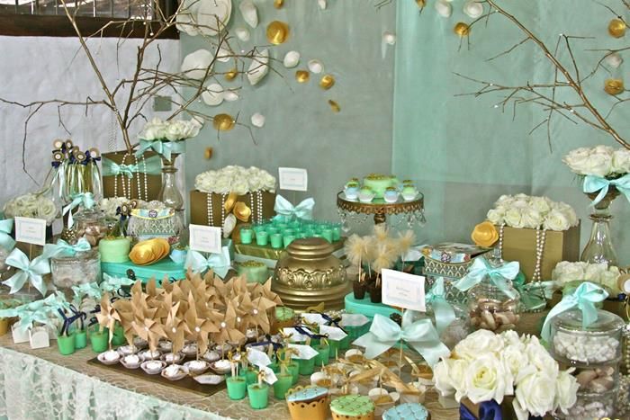 a table topped with lots of desserts and cupcakes