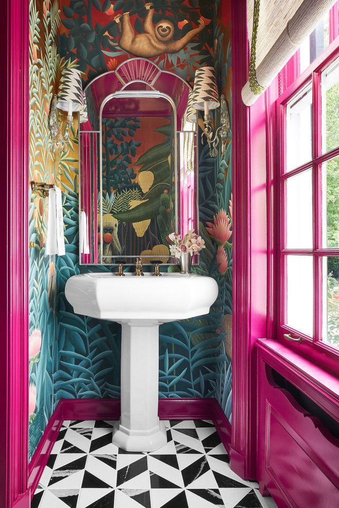 the bathroom is decorated in pink, green and gold colors with an art deco theme