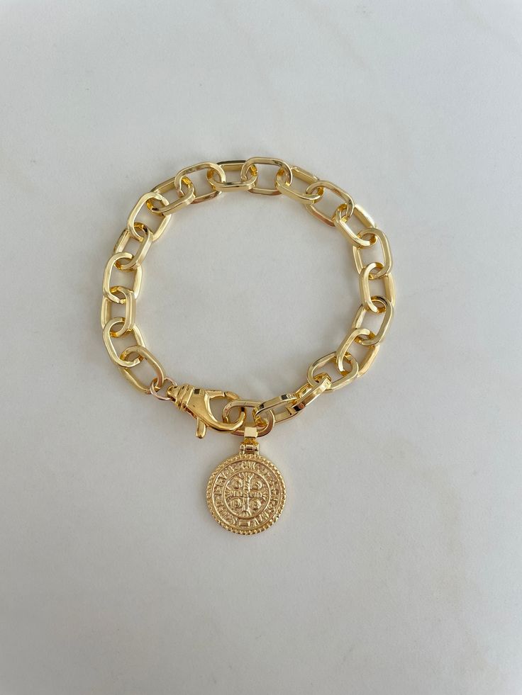 The Coin Gold Bracelet. Chunky link chain with a large spring closure allows for an adjustable length. Same design on each side of the coin. Bracelet measures approximately 7.5" The replica coin measures 3/4". Pendant and chain are gold filled, tarnish resistant Round Metal Charm Bracelet With Gold Chain, Gold Chain Metal Charm Bracelet, Adjustable Round Gold Chain Bracelet, Gold Charm Bracelet With Adjustable Chain, Gold-tone Tarnish Resistant Chain Bracelet, Gold-plated Charm Bracelet With Gold Chain, Gold-tone Round Chain Bracelet With Adjustable Chain, Gold Plated Round Charm Bracelet With Gold Chain, Gold Plated Charm Bracelet With Round Gold Chain