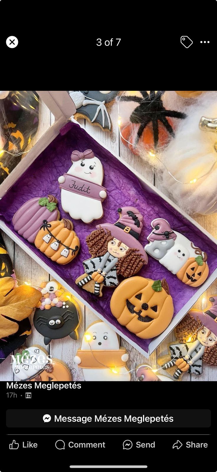 a box filled with halloween decorated cookies on top of a table