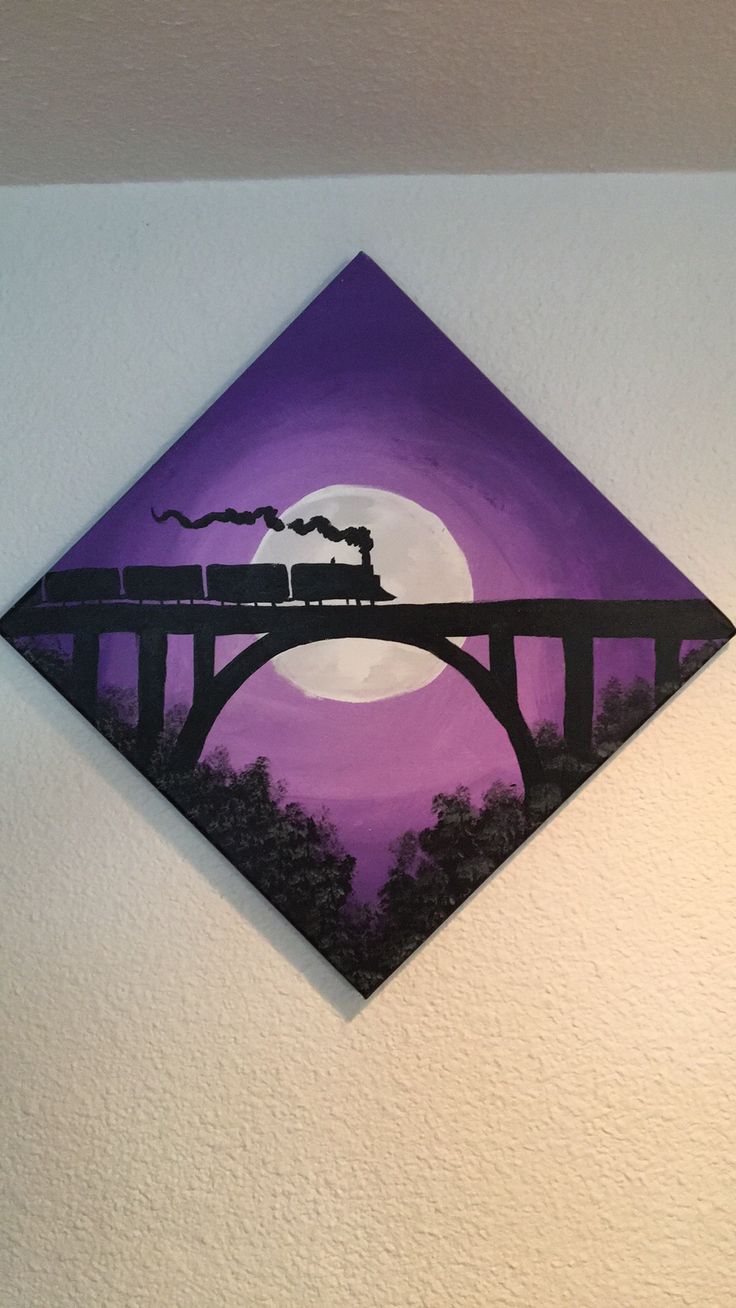 a painting on the wall of a train crossing over a bridge with a full moon in the background