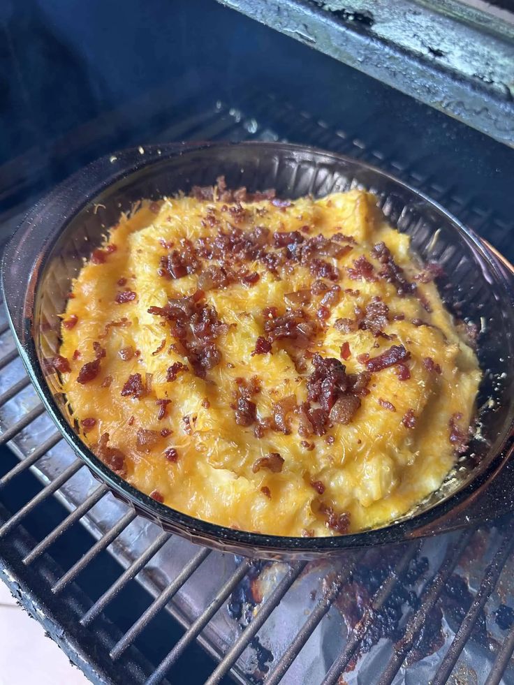 a casserole is cooking on an outdoor grill