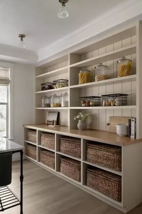 a kitchen with lots of shelves and baskets