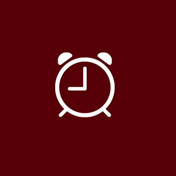 an alarm clock icon on a dark red background with the time is 11 00 pm