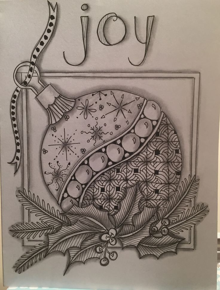 a christmas ornament with the word joy on it and holly leaves around it