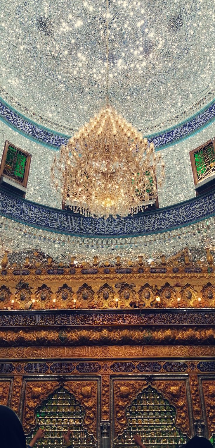 an ornate ceiling and chandelier in a building