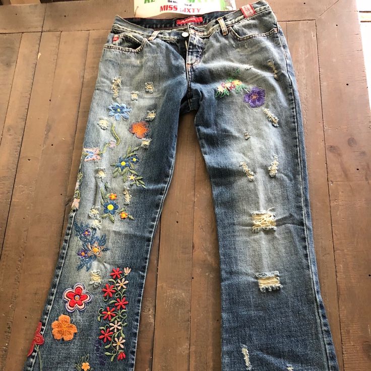 Vintage Embroidered Never Worn Jeans Mid-rise Pants With Floral Embroidery For Spring, Spring Mid-rise Pants With Floral Embroidery, Mid-rise Pants With Floral Embroidery For Summer, Casual Multicolor Floral Embroidery Bottoms, Casual Multicolor Floral Embroidered Bottoms, Summer Mid-rise Pants With Floral Embroidery, Mid-rise Floral Embroidery Summer Pants, Multicolor Floral Embroidered Bottoms For Spring, Spring Multicolor Floral Embroidered Bottoms