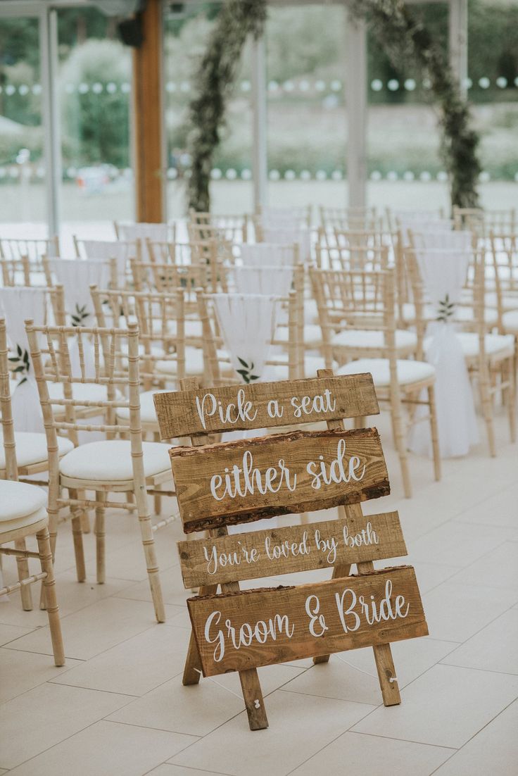 the chairs are lined up with wooden signs