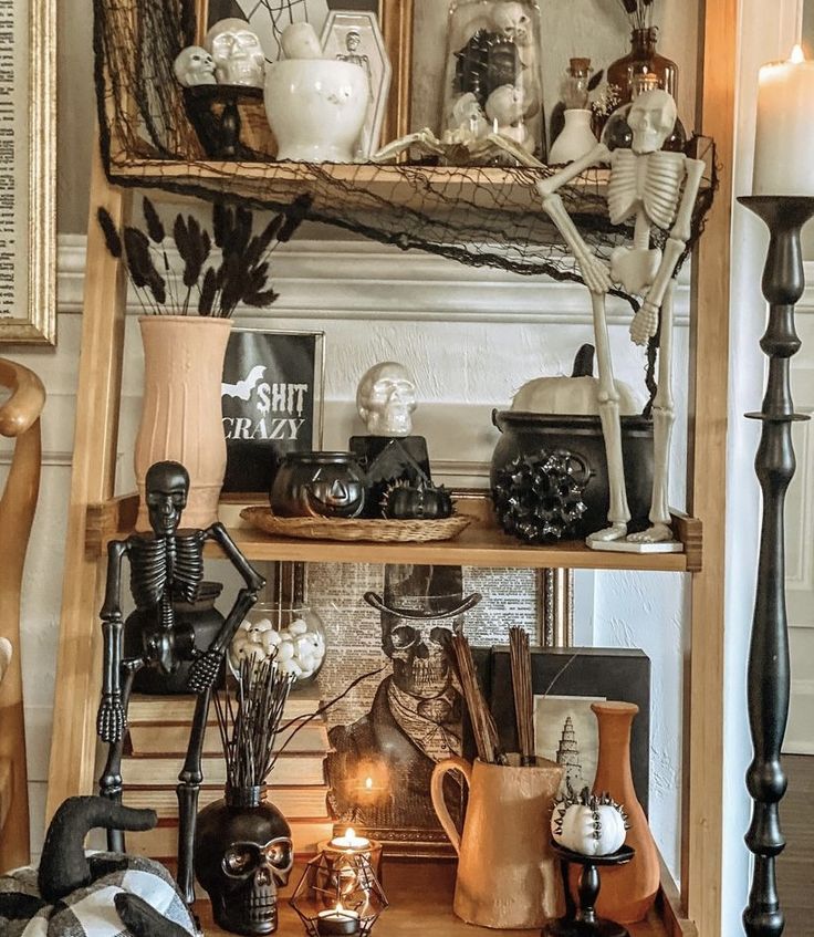 a shelf filled with halloween decorations and candles