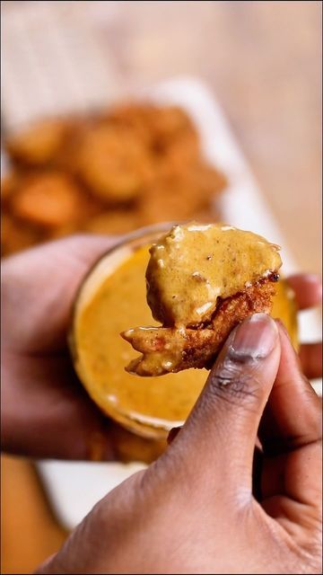 a person is holding up a half eaten food item to the camera with their left hand