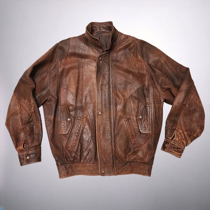 Introducing this unique 1980s vintage distressed leather Bomber Jacket in a rustic brown!  Perfect for those with a love for vintage fashion, this leather jacket exudes cool, retro vibes. The distressed look design adds a touch of edginess, while the brown leather gives it a classic look. Stand out from the crowd in this one-of-a-kind piece that combines style and nostalgia effortlessly. Add this statement jacket to your collection and rock a timeless look with a modern twist. DRY CLEANED since Rugged Brown Leather Jacket, Vintage Distressed Leather Outerwear, Vintage Distressed Brown Leather Jacket, Vintage Brown Distressed Outerwear, Vintage Distressed Brown Outerwear, Distressed Rugged Brown Outerwear, Rugged Distressed Brown Outerwear, Vintage Brown Rugged Leather Jacket For Fall, Vintage Distressed Leather Jacket