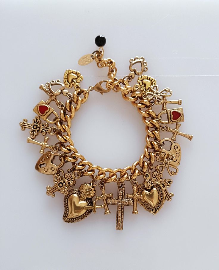 CHARMED BRACELET vintage, inspired by the bracelet created to tell a story, in this case it is hearts and crosses reminiscent of D&G's Sicily.                                                                                                                                                           and composed of a gourmet chain in Antique Gold brass. There are 24 zamak pendants, 17 cm long + 5 cm extension; created for those who love collecting memories ❤️ Gold And Silver Charm Bracelet, Schmuck Aesthetic, Charmed Bracelet, Antique Charm Bracelet, Gold Vintage Jewelry, Vintage Gold Jewelry, Charm Bracelet Vintage, Dope Jewelry Accessories, Bracelet Inspired