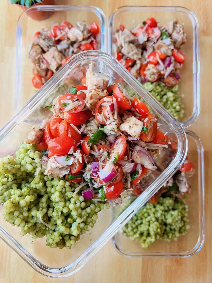 three plastic containers filled with food on top of a wooden table