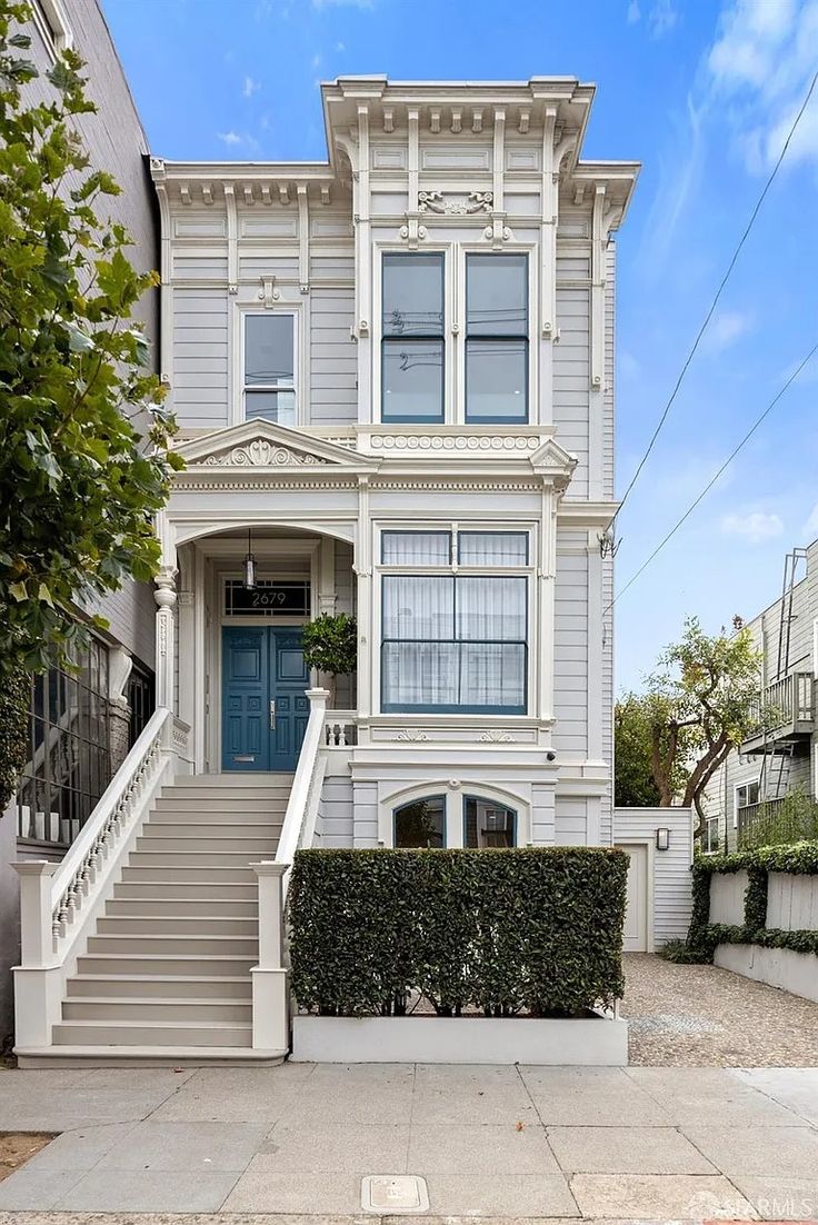 this is an image of a two story house in san francisco with stairs leading up to the front door