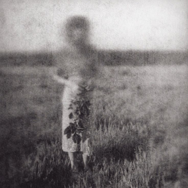 a black and white photo of a person in a field