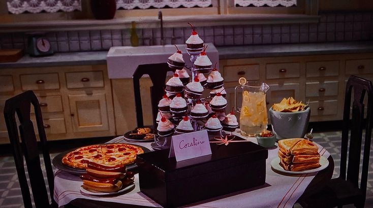 a table topped with pizza and other food items