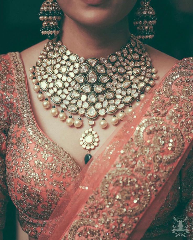 a woman wearing an elaborate necklace and earrings