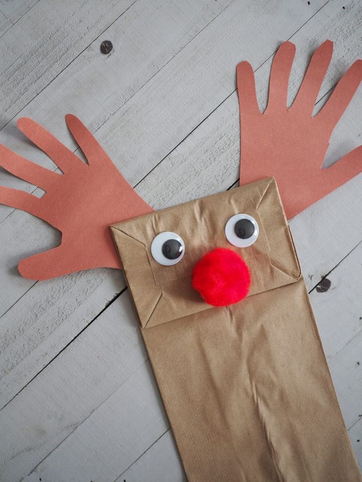 a paper bag with a reindeer's head on top of it and eyes painted red