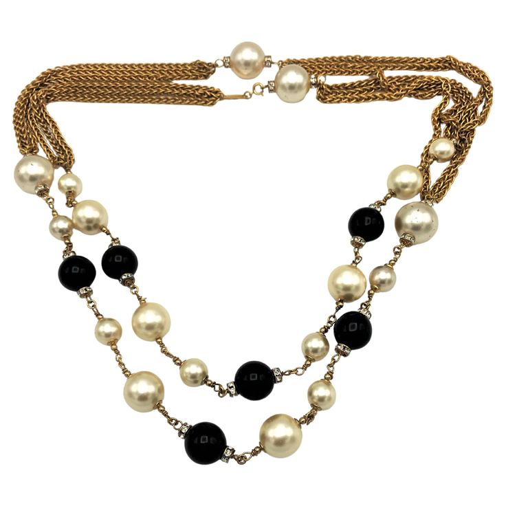 CHANEL Sautoir/necklace (Made in France) consisting of handmade pearls and black balls from Gripoix Paris and with rhinestone rondelles and fine gold-plated chains in between. This Chanel sautoir can be worn on many occasions, whether long or double, here is a small spring ring as a closure. Dimensions Length of teh Sautoir 128 cm Pearls in the size from 1,6 cm to 0.7 cm Black glas balls by Gripoix Paris 1,5 cm in diameter 4 gold-plated chain strands with 3 chains each complete the sautoir Singed with the CHANEL CC = from the1990s The necklace has a small spring ring clasp, next to the Chanel tag. Good condition - CHANEL IS FOREVER ! Vintage Chain Necklace, Nautical Necklace, Gold Collar Necklace, Double Chain Necklace, Chanel Necklace, Glass Balls, Gold Rope Chains, Chanel Jewelry, Chain Necklaces