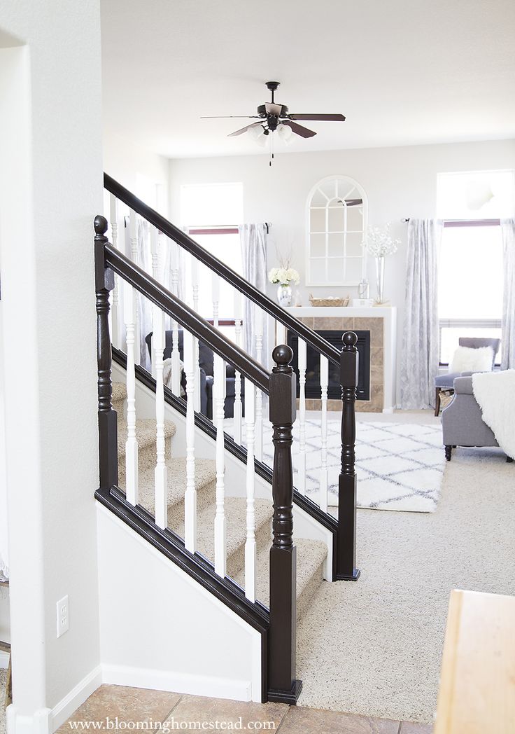 a white and black stair case in a house