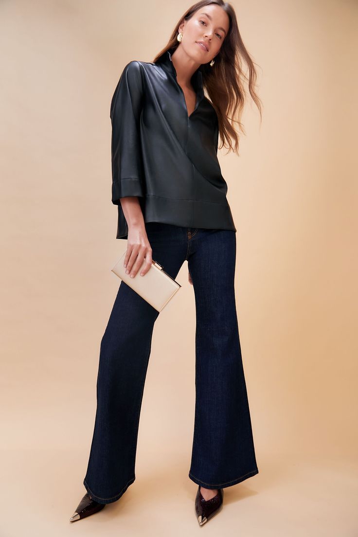 The Margot Blouse is one of our favorite silhouettes, and is now updated in a soft faux leather for a chic look. The sleek stand collar creates a classic, sophisticated look but also pairs well with denim for a more casual vibe. We are wearing this top from meetings to date night with a quick change of accessories! Stand collar V-neckline Three-quarter length sleeves Slits at back of elbows Faux leather Material: 55% Synthetic, 45% Polyester Care: Hand wash cold extra gentle, hang to dry Accessories Stand, Cocktail Attire, Whale Tail, Fly High, Weekend Wear, Night Looks, Flared Jeans, Fashion House, Kitten Heel