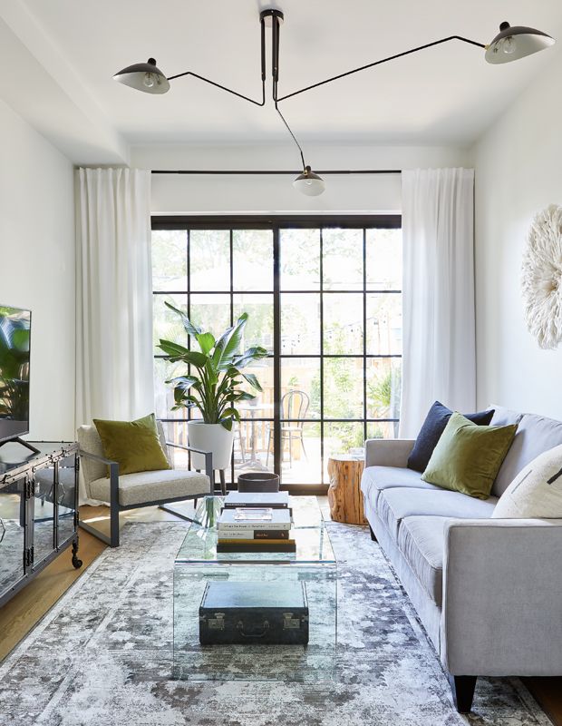 a living room filled with furniture and lots of windows