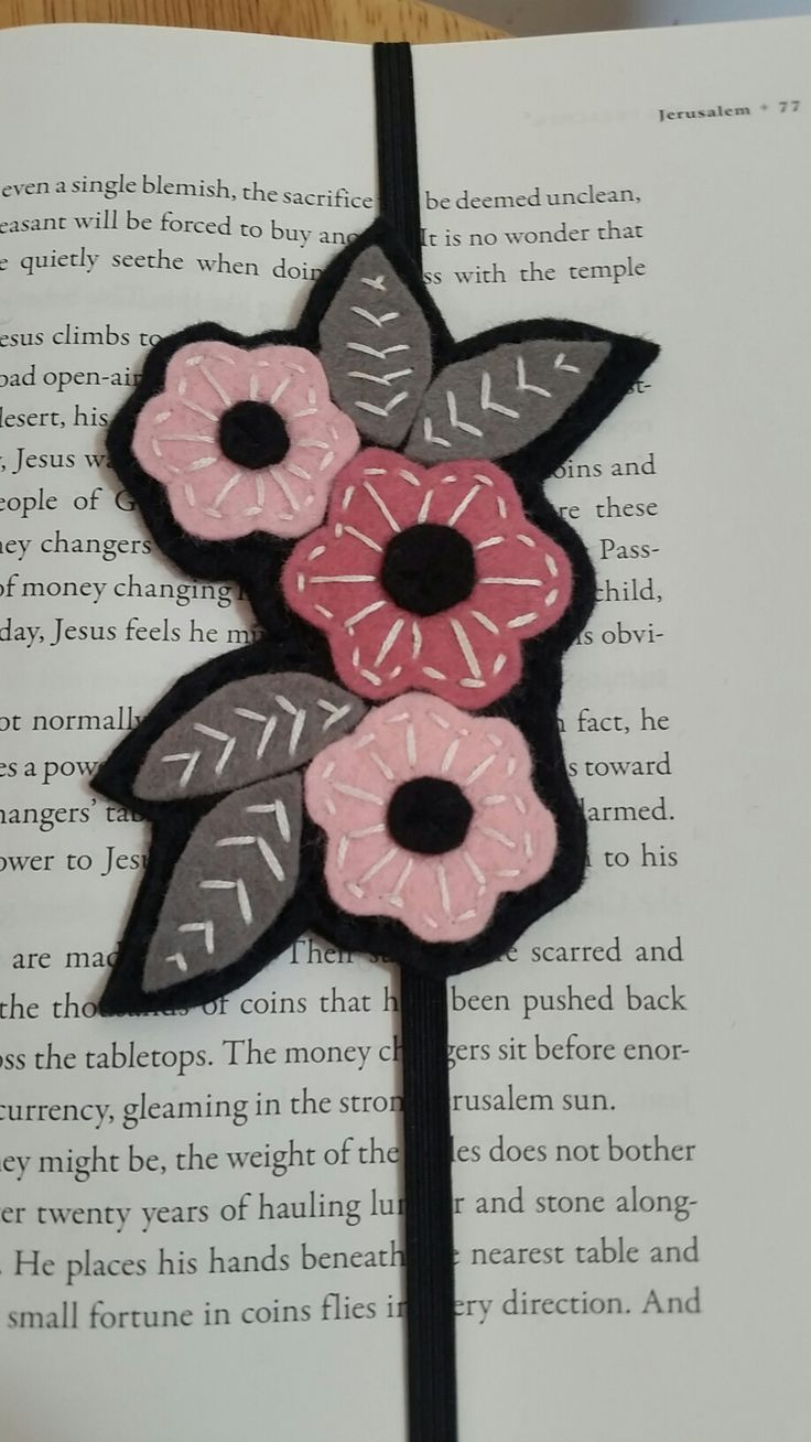 an open book with some flowers on it