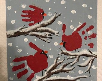 a painting of two red birds sitting on top of a tree branch in the snow