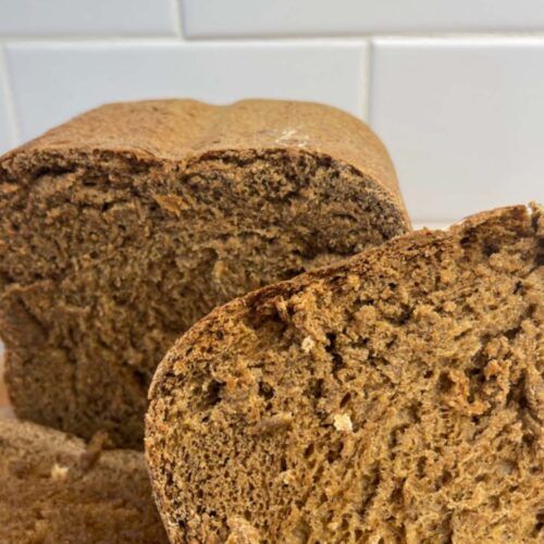 two loaves of bread sitting on top of a cutting board