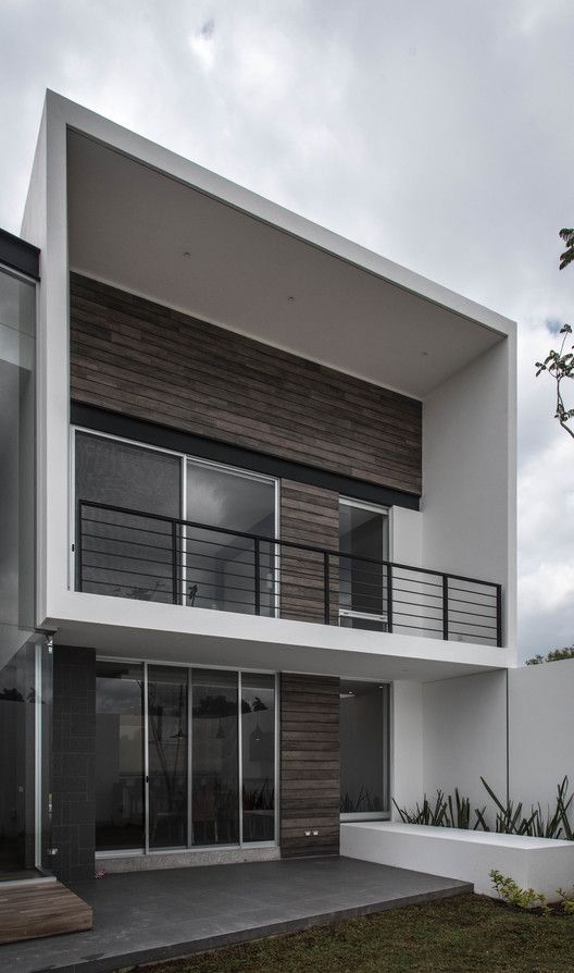 a modern house with glass doors and balconys