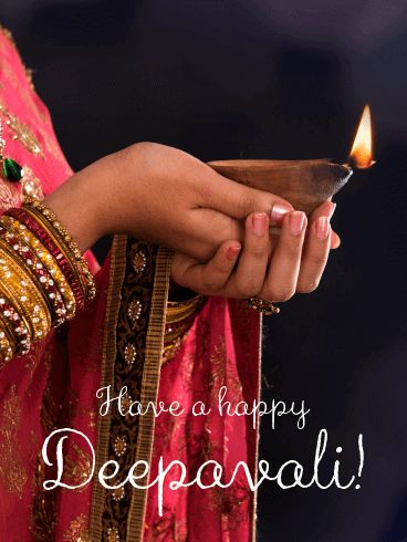 a woman holding a lit candle with the words have a happy deepavali