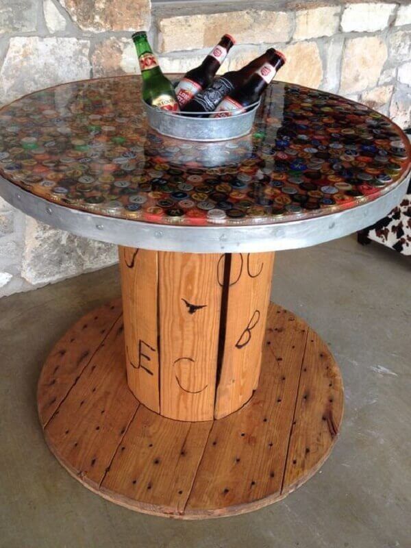 two beer bottles are sitting in a bucket on top of a table made out of wood