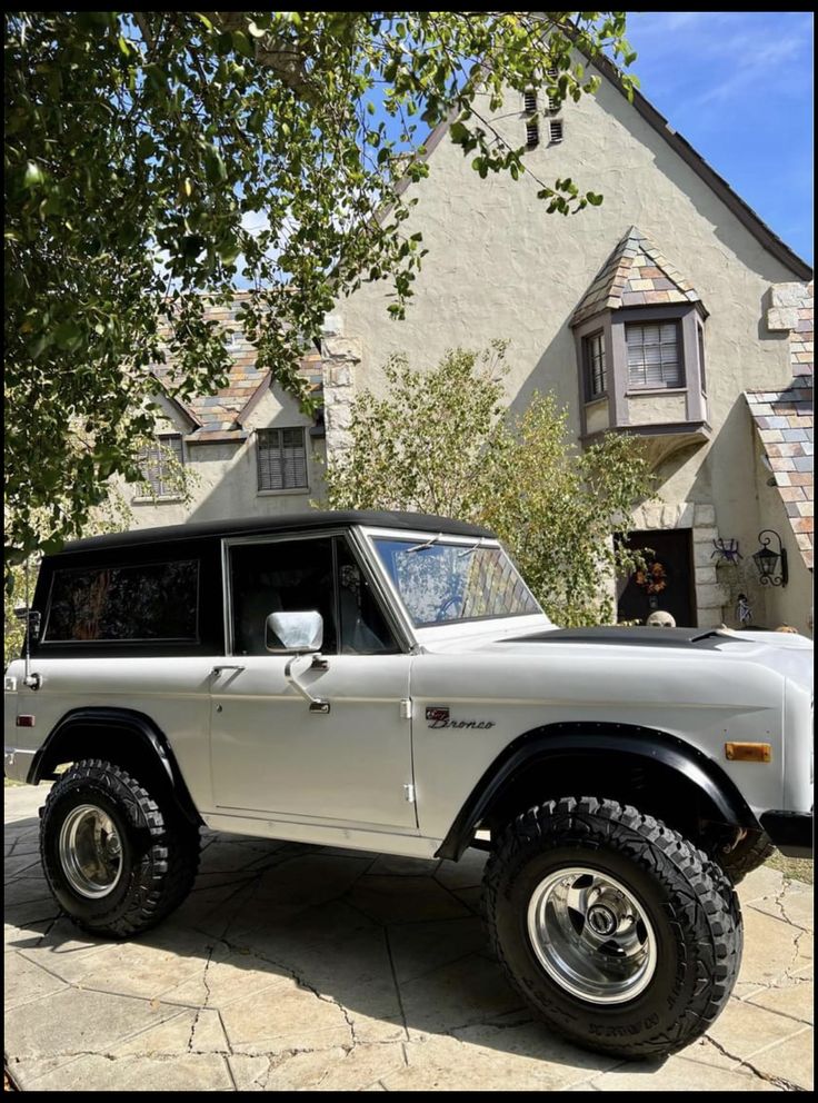 a white truck parked in front of a house