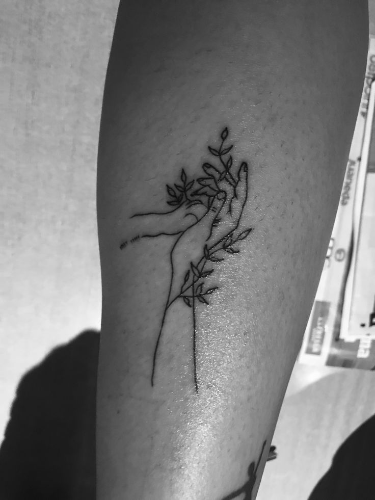 a black and white photo of someone's arm with a tattoo on it