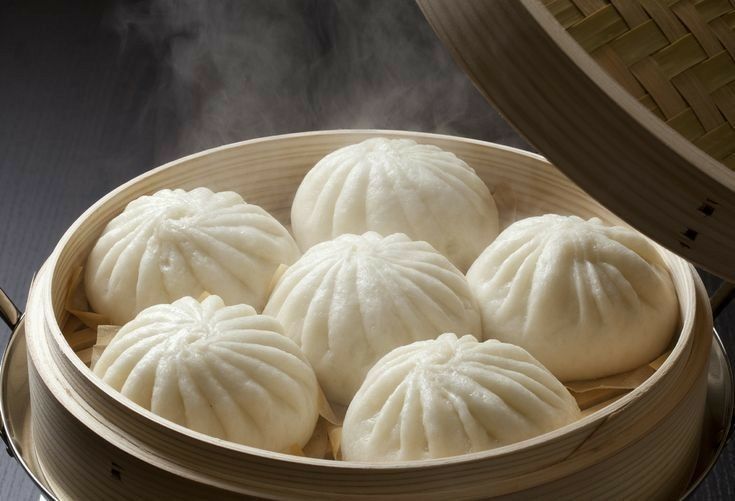 steamed dumplings in a bamboo steamer basket