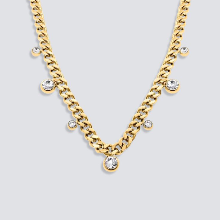 DESCRIPTION & DETAILS Complete your formal look with a touch of luxury. This smooth cuban chain necklace is the perfect accessory for any special occasion. Made with cubic zirconia, these necklace add a touch of glamour to any outfit. Give the gift of elegance to someone special in your life. Plating: 14k Gold Materials: 14K Gold on Stainless Steel Measurements: 40 + 5 cm extender Hypoallergenic SUSTAINABILITYIn-house plating - All pieces are hand crafted by our in-house jewellers ensuring a hig Party Cuban Link Curb Chain Necklace, Party Cuban Link Necklace, Gold Cubic Zirconia Chain Necklace, Elegant Cuban Link Chain Necklace For Parties, Elegant Gold Cuban Link Necklace With Cubic Zirconia, Elegant Cubic Zirconia Chain Link Necklace, Elegant Chain Necklace With Diamond Accents, Elegant Chain Necklace With Rhinestones, Elegant Chain Link Necklace With Diamond Accents