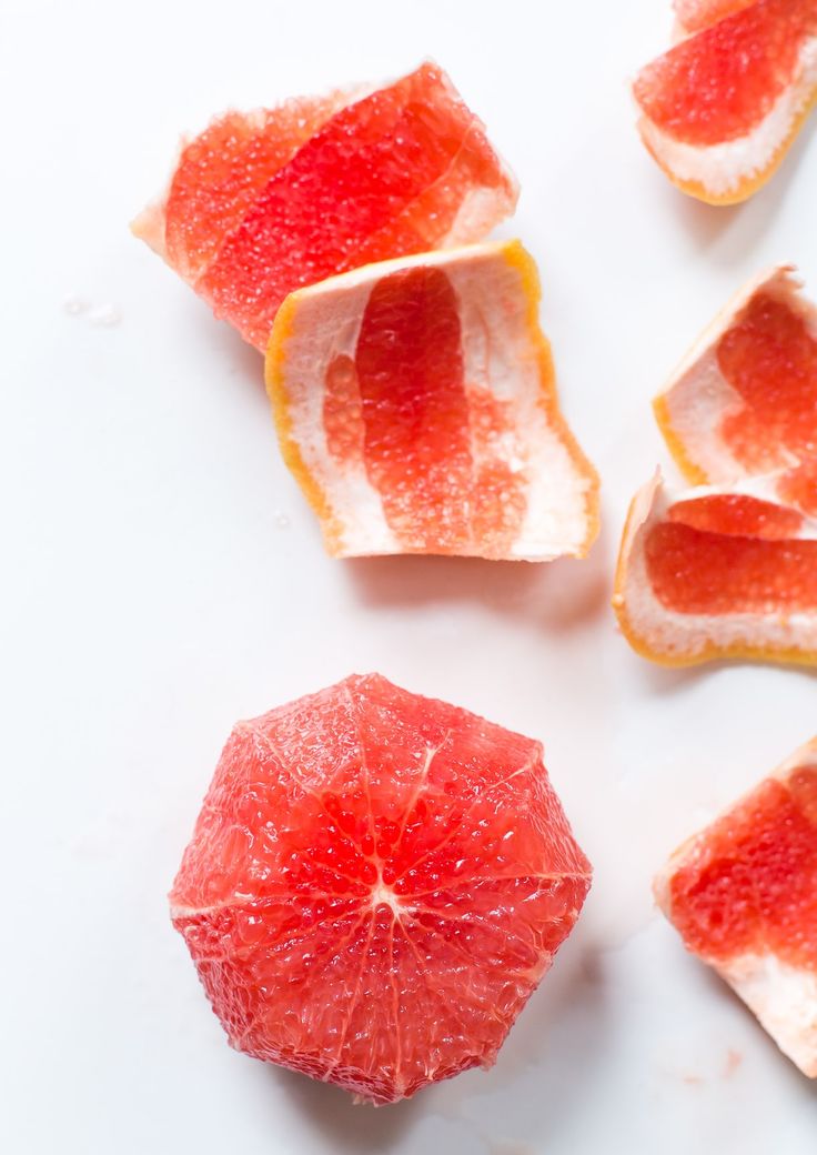 slices of grapefruit and blood oranges on a white surface