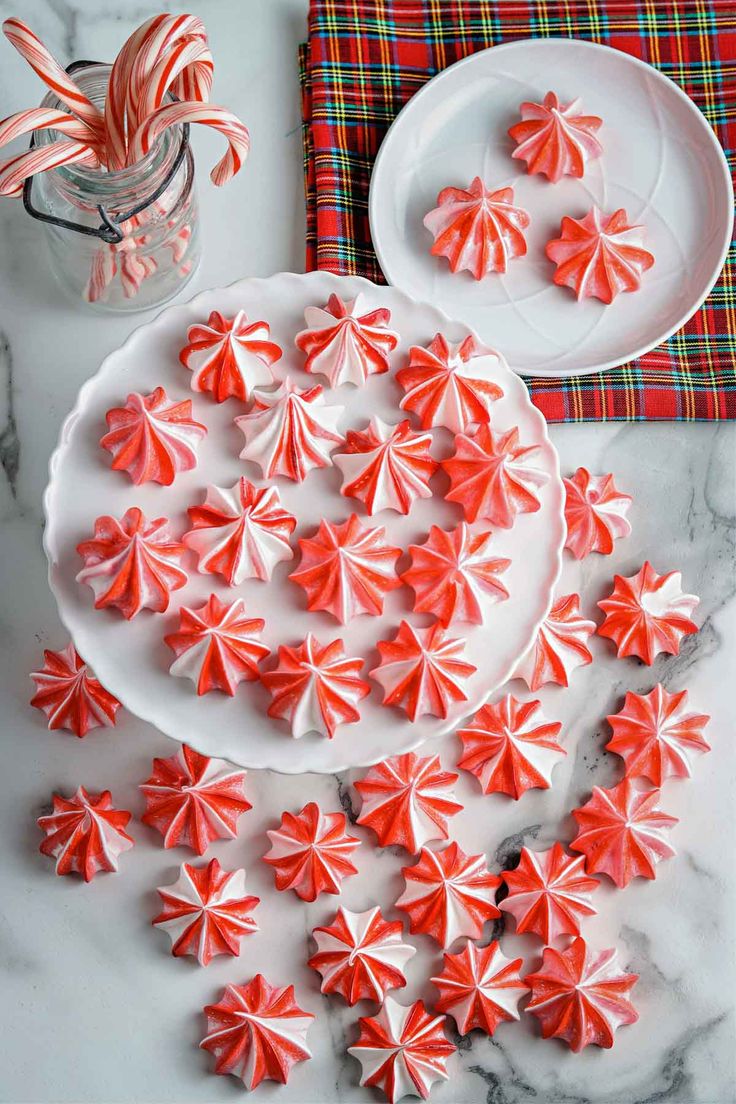 red and white candies are arranged on a plate