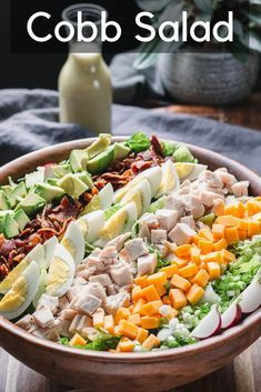 a wooden bowl filled with different types of food