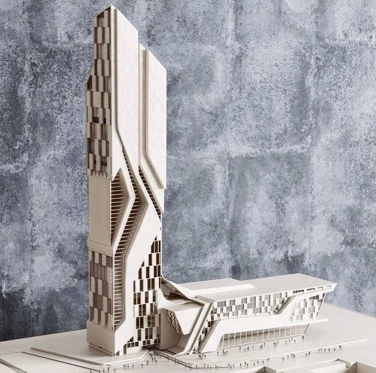 an architectural model of a building on top of a table in front of a wall