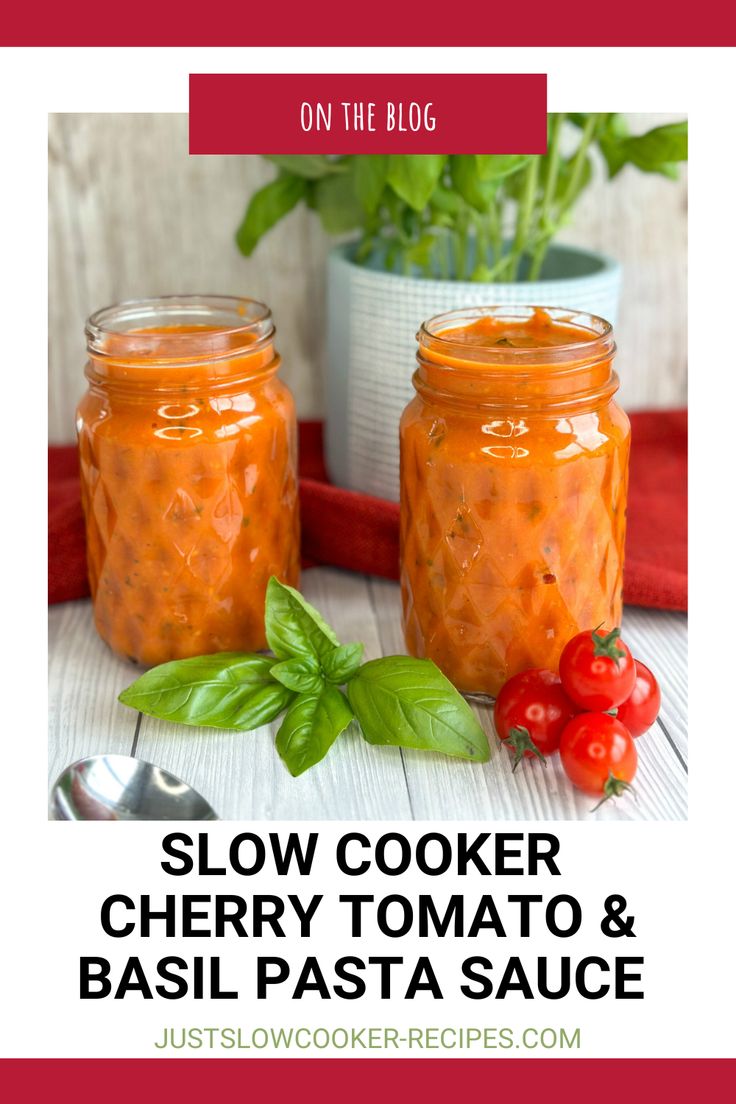 two mason jars filled with cherry tomato sauce and basil leaves on the table next to each other