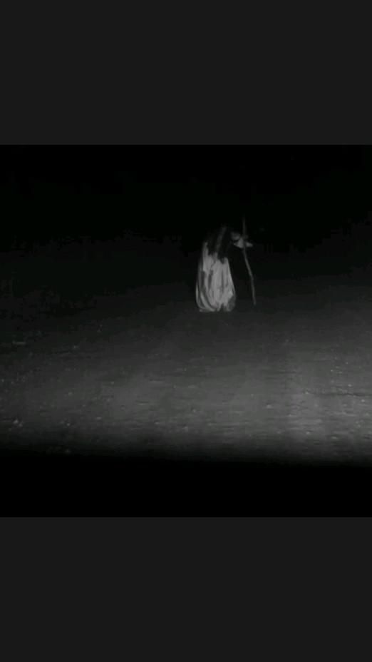 a black and white photo of a person in the dark