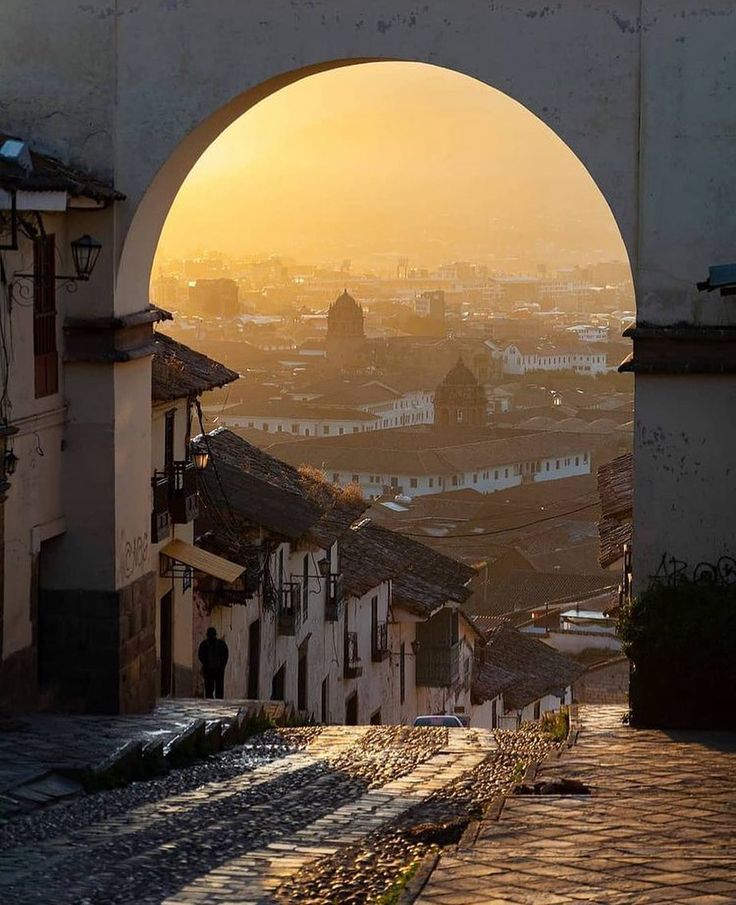 the sun is setting over an old city