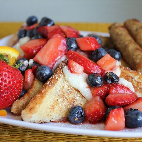 french toast with strawberries, blueberries, oranges and strawberries on top