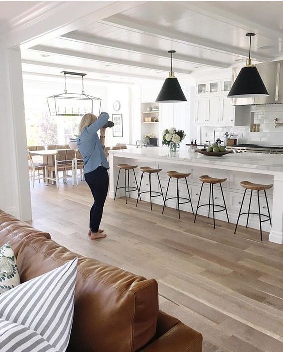 a woman standing in the middle of a living room