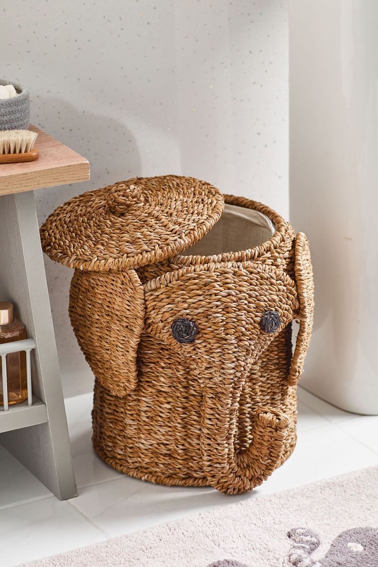 a wicker basket sitting on the floor next to a table