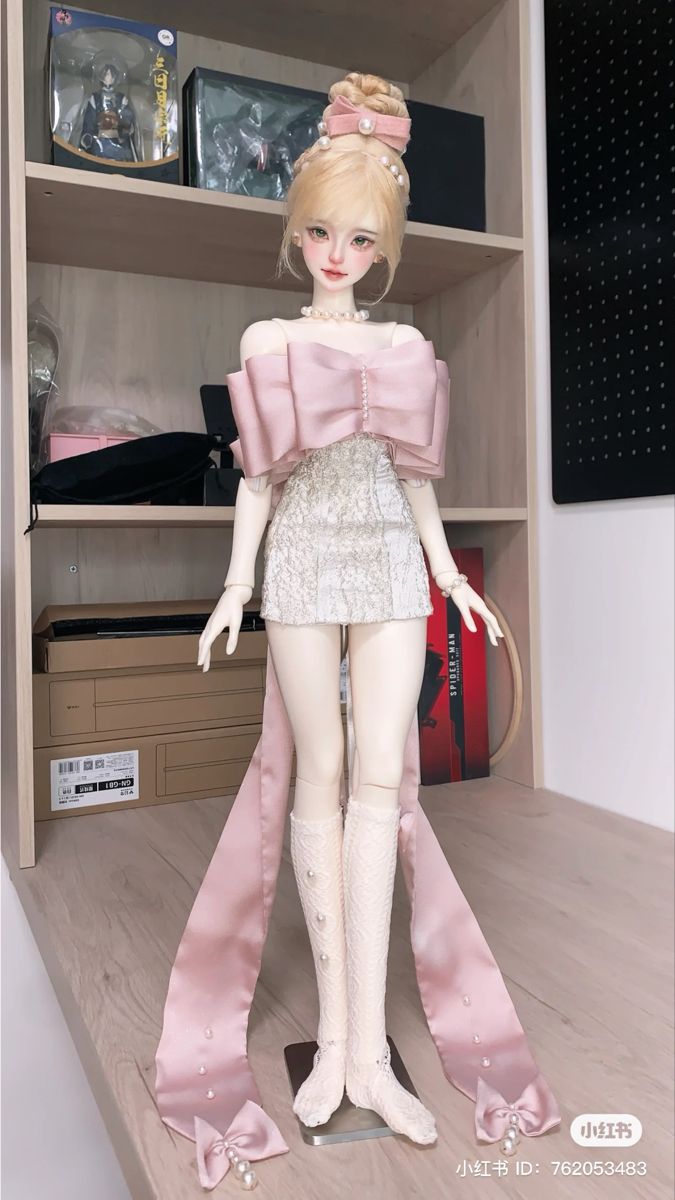 a doll is standing in front of a book shelf